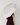 A person wearing a dark burgundy ribbed dress holds a large open UPF50+ sun umbrella over their head, viewed from behind against a plain light gray background.