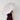 A person wearing a dark burgundy ribbed dress holds a large open UPF50+ sun umbrella over their head, viewed from behind against a plain light gray background.