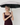 Woman holding UPF50+ sun umbrella. black on the inside, brand print on the outside. 